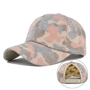Detail of pink camo knit ponytail cap featuring a crisscross elastic back and velcro strap