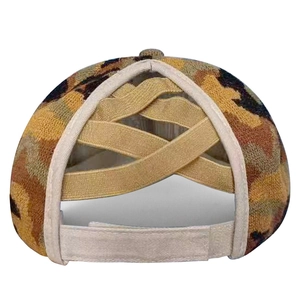 Detail of ponytail baseball cap featuring camouflage pattern and elastic criss-cross back
