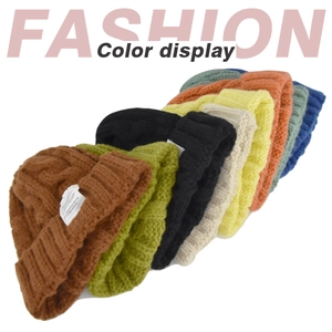 Detailed knit texture and color selection of twist-braided winter beanies with labels