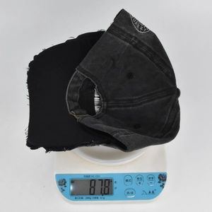 Close-up showing the weight of a vintage washed skull baseball cap on a scale