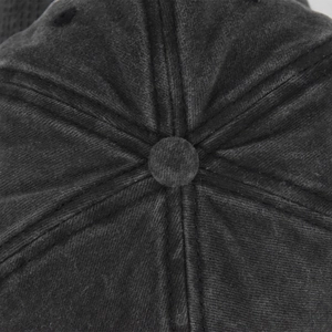Macro shot of washed dark gray cotton canvas baseball cap top with stitched crown details