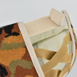 Detail view of the camouflage knit hat back with velcro strap and elastic ponytail bands