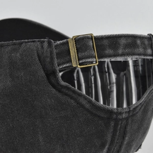 Macro detail of washed cotton baseball cap with adjustable antique bronze metal buckle