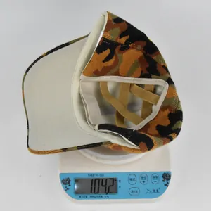 Close-up showing a camouflage ponytail baseball cap being weighed at 104.2g on a digital scale