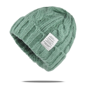 Grass green cable-knit beanie hat for winter with stylish white woven label detail