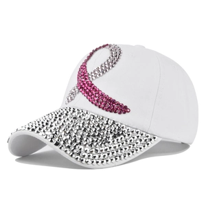 Close-up of pink rhinestone ribbon and sparkling silver gems on a white baseball cap