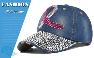 Detail of blue denim baseball cap with rhinestone ribbon and studded brim