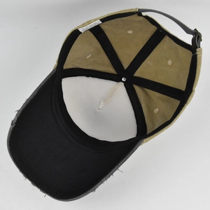 Internal view of graffiti baseball cap showing stitching, wash label, and metal buckle