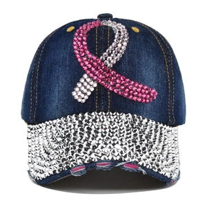 Distressed dark blue denim baseball cap with pink rhinestone ribbon and silver studded brim