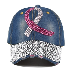 Macro detail of pink rhinestone ribbon and silver studs on washed denim cap brim