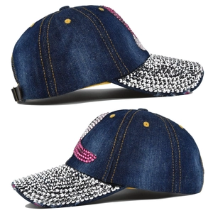 Macro view of blue denim baseball cap featuring silver studs and rhinestone patterns