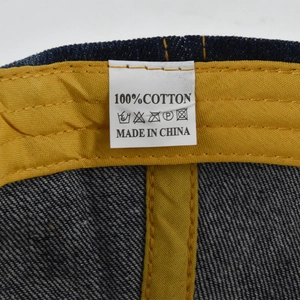Macro shot of the 100% cotton wash label and twill sweatband inside the denim baseball cap