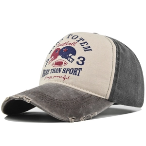 Detail of vintage washed baseball cap featuring graffiti print and distressed frayed edges