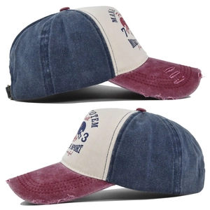 Detail of distressed brim and vintage graffiti print on a washed patchwork baseball cap