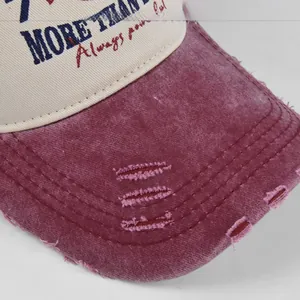 Macro detail of distressed brim with triple stitching and graffiti print on baseball cap