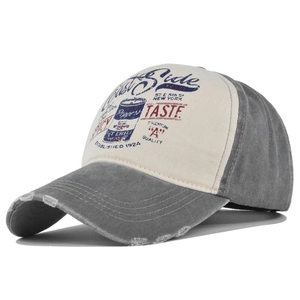 Close-up of distressed brim and vintage graffiti print on color-block baseball cap