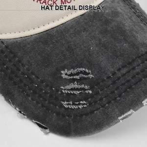 Detail view of distressed baseball cap showing washed fabric and frayed brim stitching