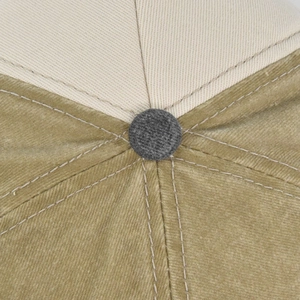 Top macro view of the two-tone corduroy baseball cap with gray button and stitching