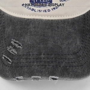 Close-up of distressed brim detail on a vintage washed graffiti baseball cap