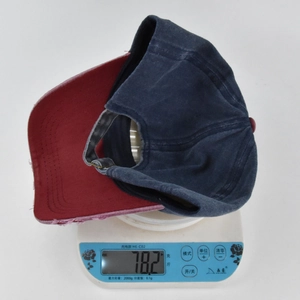 Detailed shot of distressed baseball cap on a digital scale showing weight of 78.2 grams
