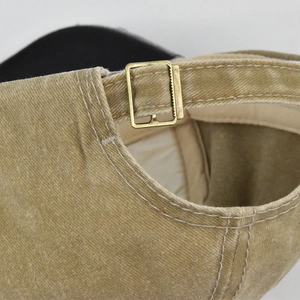 Detail of vintage washed canvas baseball cap with antique bronze metal slide buckle