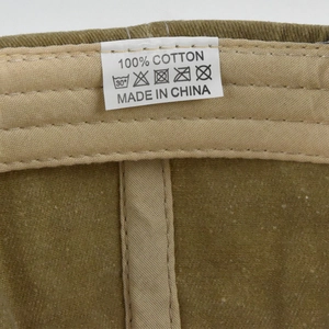 Macro detail of cotton corduroy hat interior showing stitching and care label