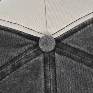 Close-up of baseball cap top showing contrast stitching and premium washed twill texture