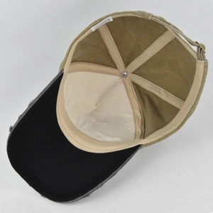Detail view of cotton inner lining with sweatband and wash label on distressed baseball cap