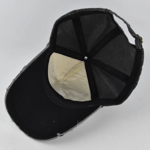 Inside view of distressed denim baseball cap showing sweatband and adjustable metal buckle