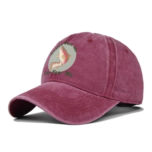 Close-up of vintage burgundy washed cotton baseball cap with fish print and humor slogan