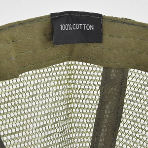 Detail view of cotton label and breathable mesh on army green camo baseball cap