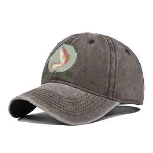 Detail of colorful fish print and slogan on vintage washed cotton baseball cap