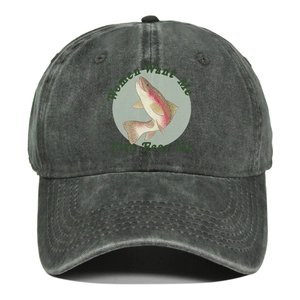 Macro view of washed gray denim baseball cap with fish embroidery and slogan detail