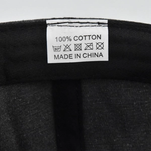 Detail view of cotton baseball cap interior featuring white 100% cotton washing label