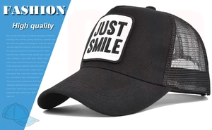 Close-up of black breathable trucker hat with white Just Smile embroidery patch