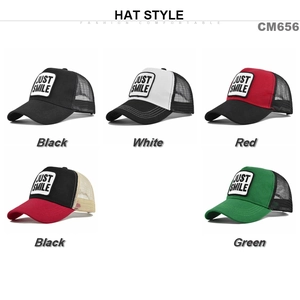 Detail showing five colors of breathable mesh trucker hats with JUST SMILE patch