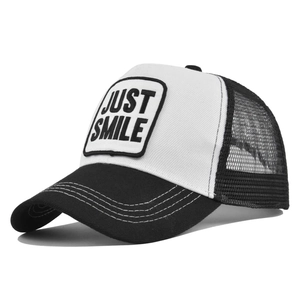 Detail of breathable trucker hat with JUST SMILE patch and mesh back design