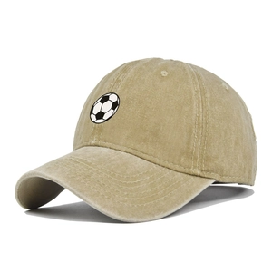 Close-up of khaki washed cotton baseball cap with embroidered soccer ball pattern