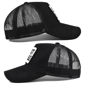 Detailed side view of a black trucker hat featuring breathable mesh and JUST embroidery