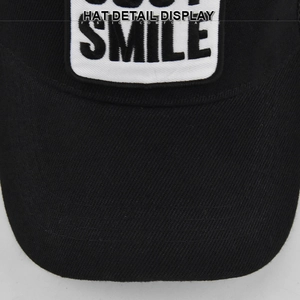 Macro detail of high-quality embroidery with SMILE patch on black cotton baseball cap