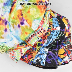 Close-up of stacked bucket hats with tie-dye patterns and graffiti print details