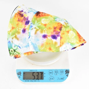 Close-up of lightweight colorful tie-dye bucket hat being weighed on a digital scale