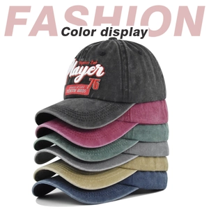 Detailed stack of washed cotton baseball caps with vintage 3D Player embroidery in six colors