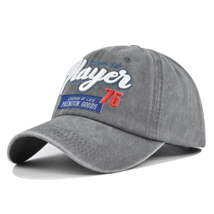 Macro detail of the Player 76 3D embroidery and washed vintage fabric texture on grey cap