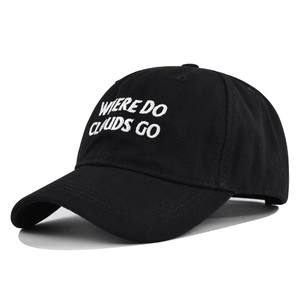 Detailed view of white 'WHERE DO CLOUDS GO' embroidery on a black cotton baseball cap