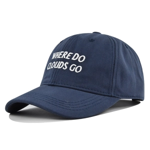Detail of navy blue cotton baseball cap featuring white WHERE DO CLOUDS GO embroidery