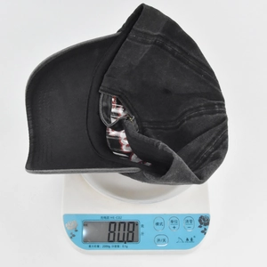 Detailed view of vintage washed baseball cap weighing 80.8g on a digital scale