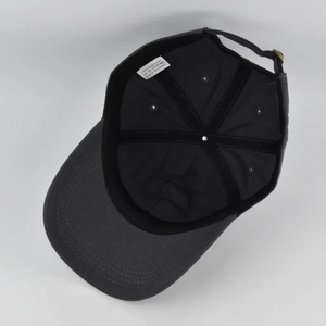 Detailed interior of the cotton baseball cap showing reinforced seams and metal buckle