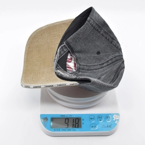 Weight measurement of a washed cotton baseball cap showing 91.8g on a digital scale
