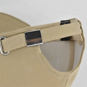 Detailed close-up of khaki baseball cap featuring metal slide buckle and fabric strap